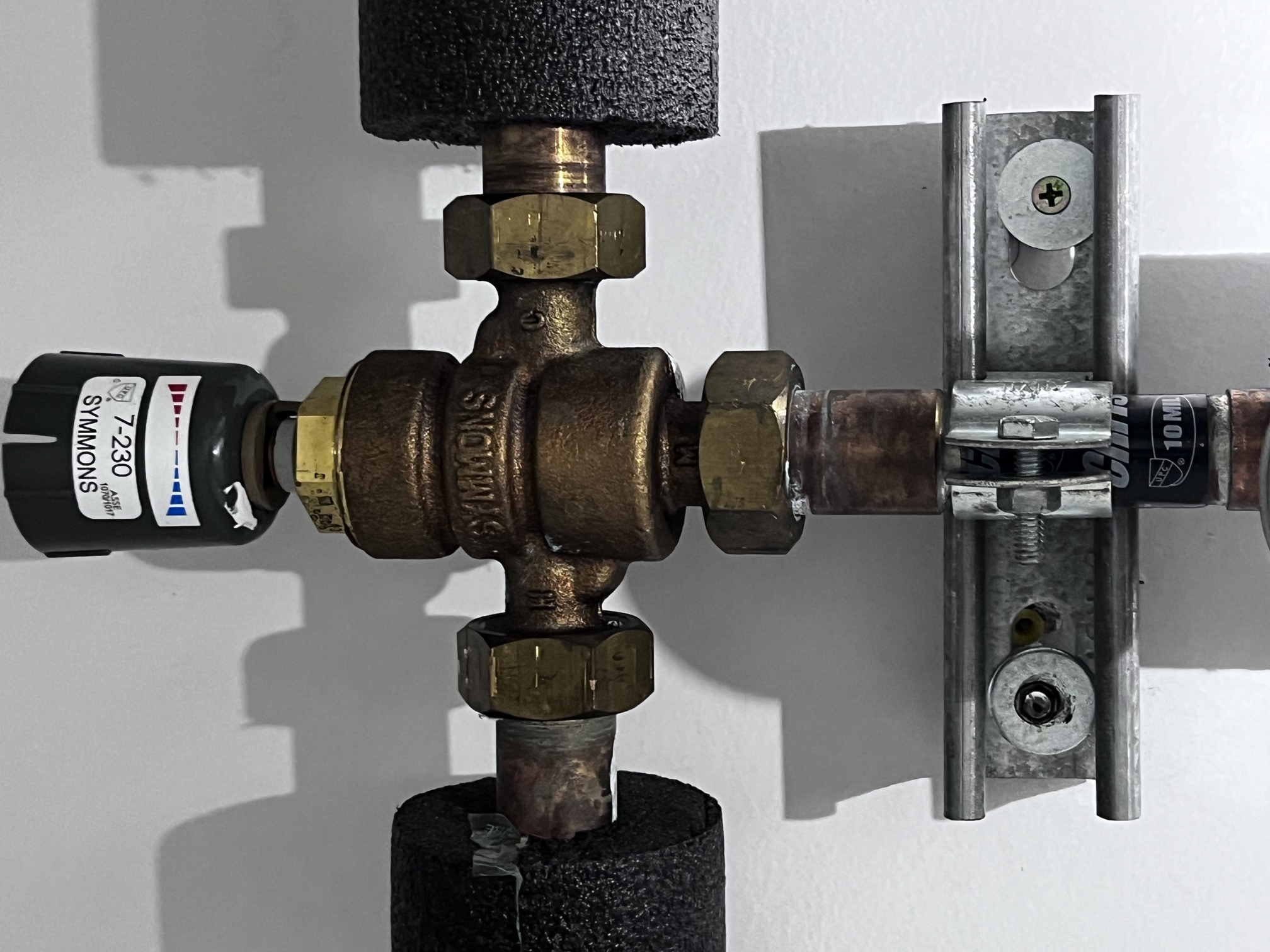 Symmons mixing valve assembly in healthcare facility plumbing system
