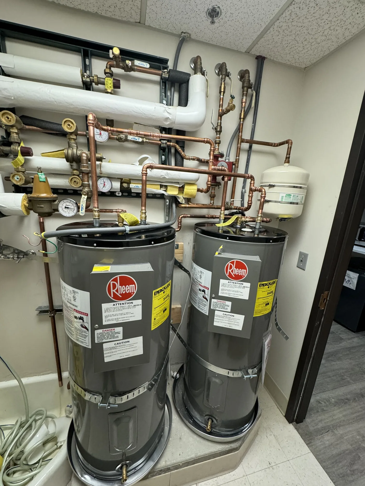 Dual Rheem commercial water heaters with copper piping installed in Anaheim