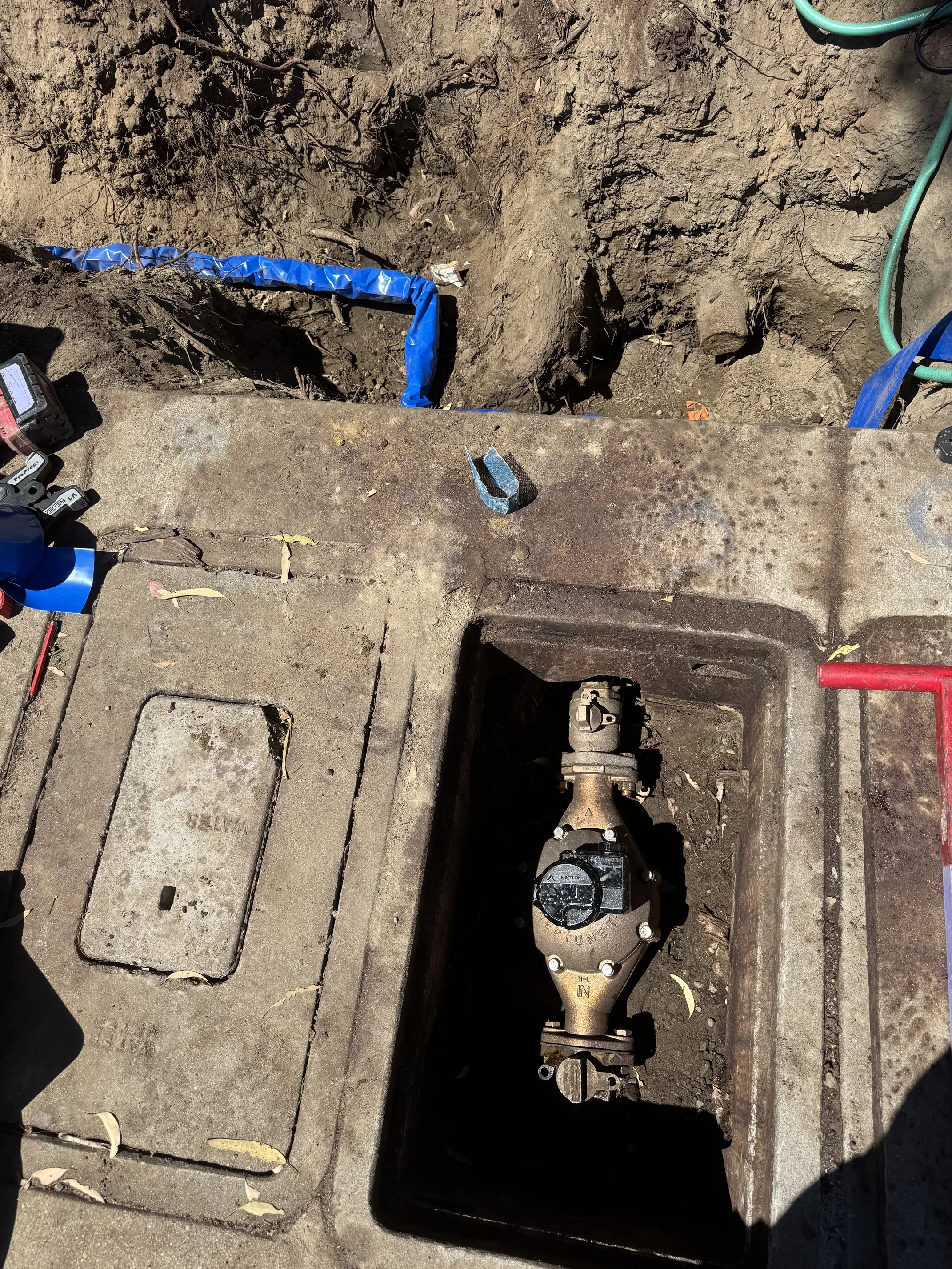 Backflow preventer valve in underground meter box during water supply line service