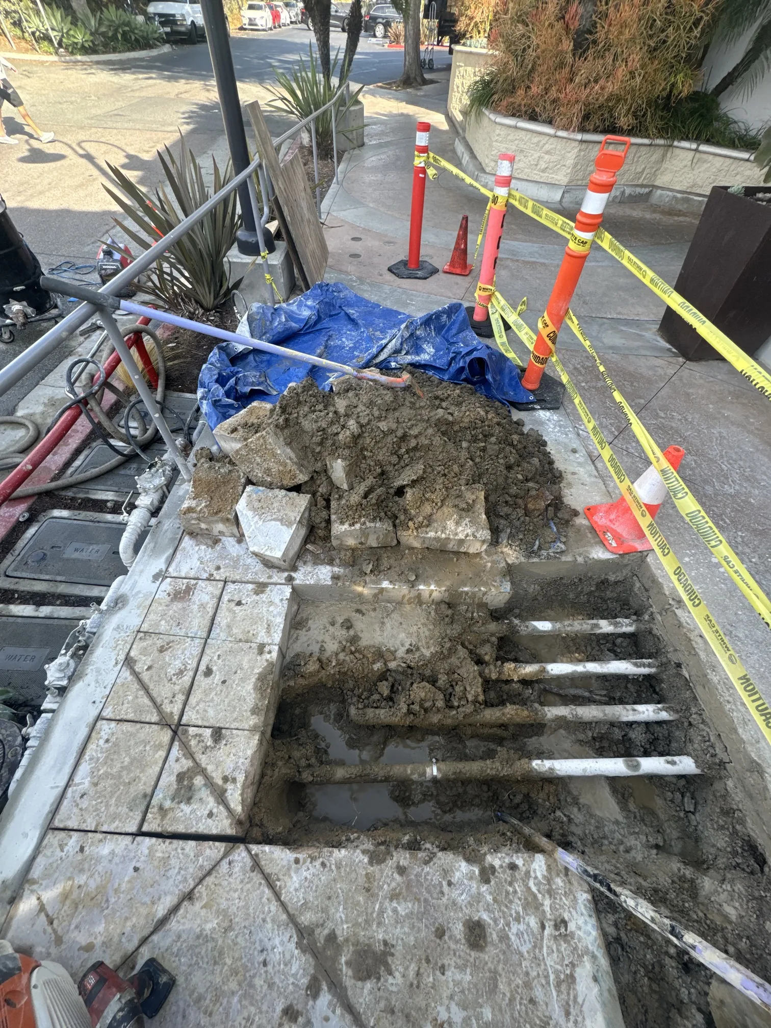 Sidewalk excavation exposing underground plumbing infrastructure in Los Angeles County