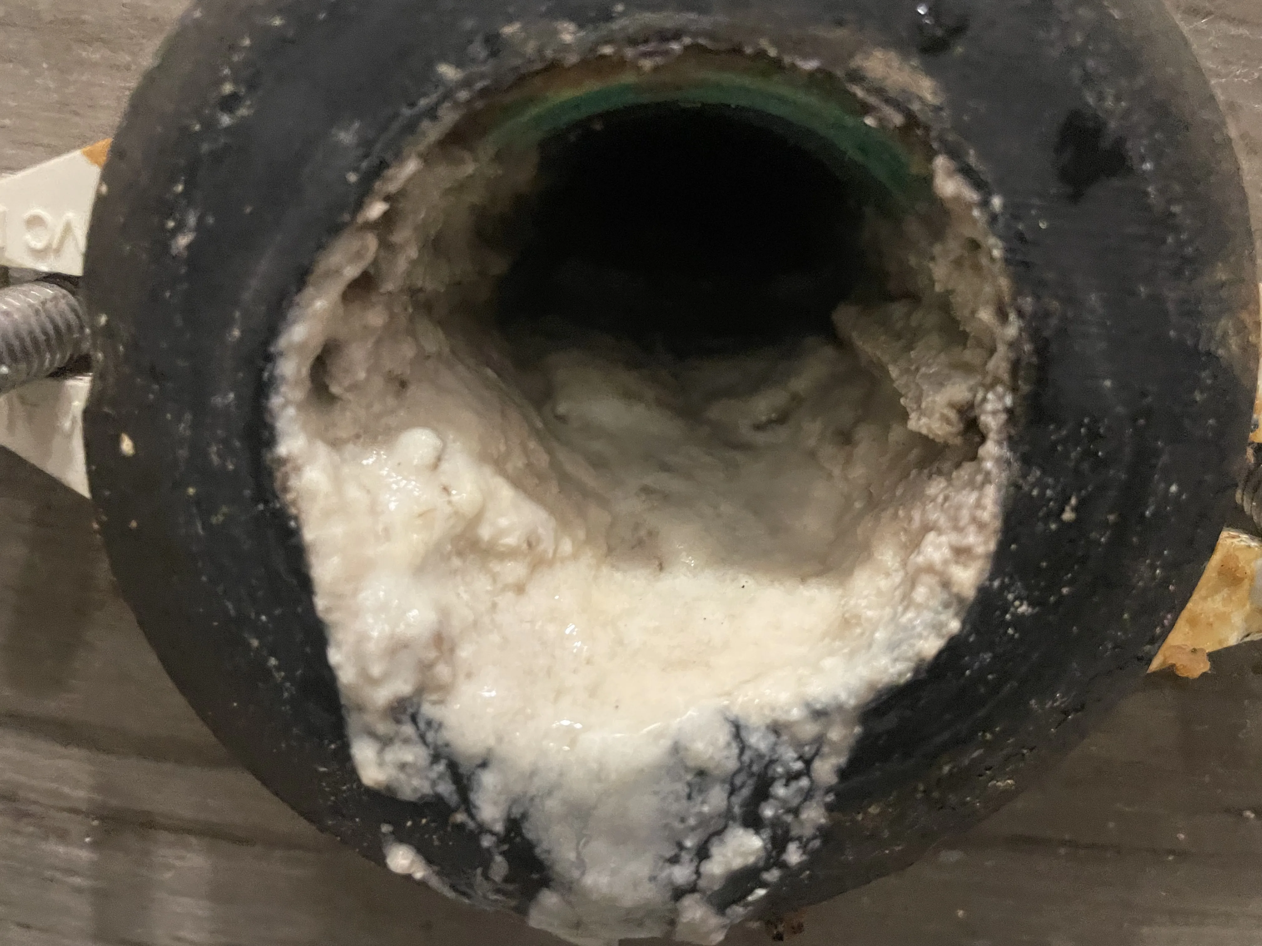 Heavy grease and calcite buildup inside commercial drain pipe before hydro-jetting