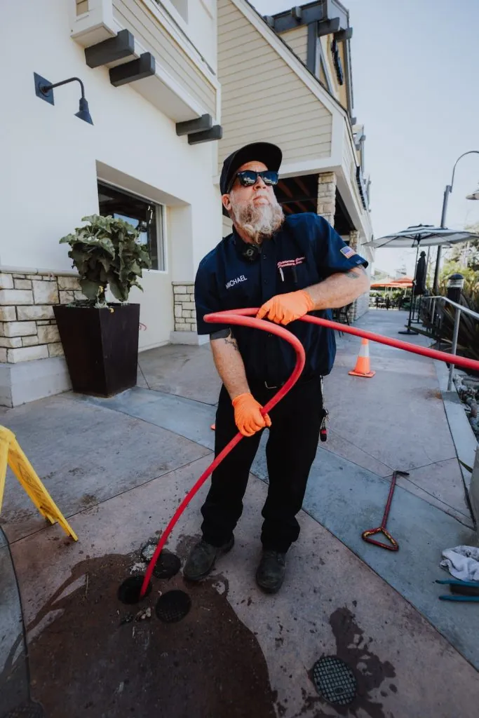 California Coast Plumbers technician setting up for a commercial hydro-jetting service